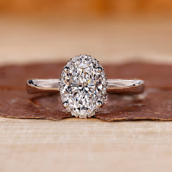 Halo Setting Diamond Ring in white gold with a brilliant oval cut diamond.
