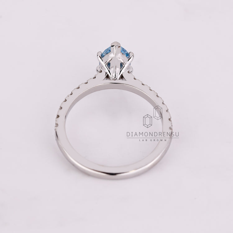 Buy engagement ring with marquise cut blue diamond and cathedral setting.
