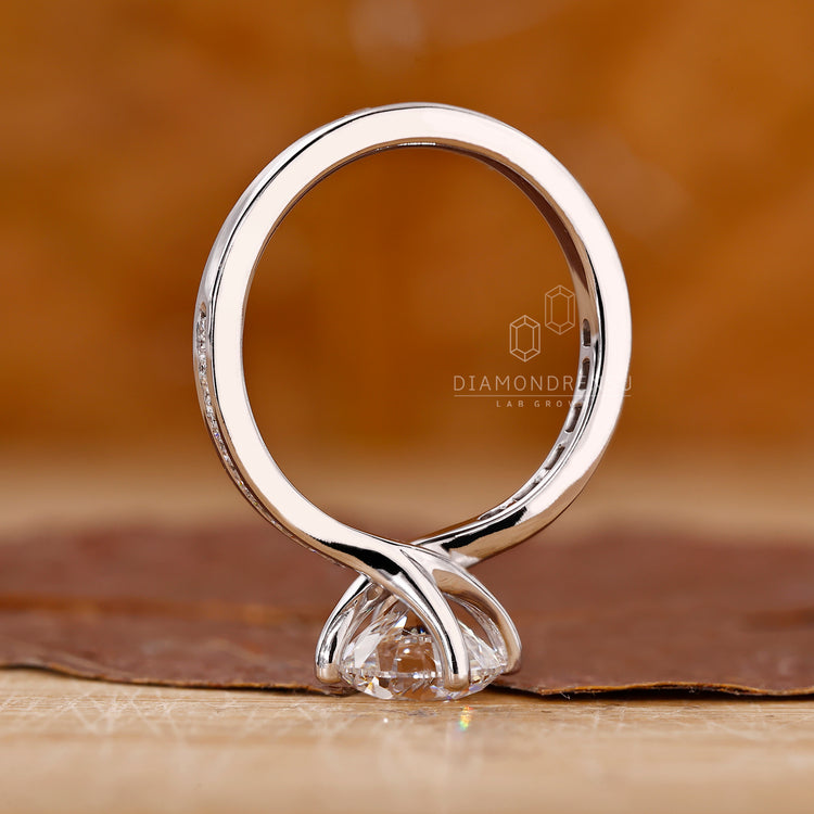 Handmade ring featuring a round diamond centerpiece.

