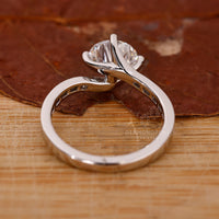 Elegant bypass engagement ring with smooth open design.
