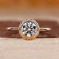Vintage Diamond Ring with a round cut diamond, set in a yellow gold band.
