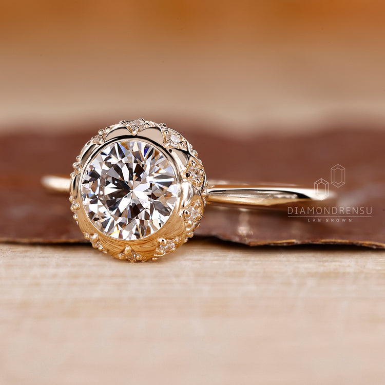 Bezel Set Engagement Ring with a round cut diamond and a tapered shank.
