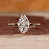 Marquise cut diamond engagement ring made with yellow gold.
