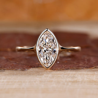 Marquise cut diamond engagement ring made with yellow gold.
