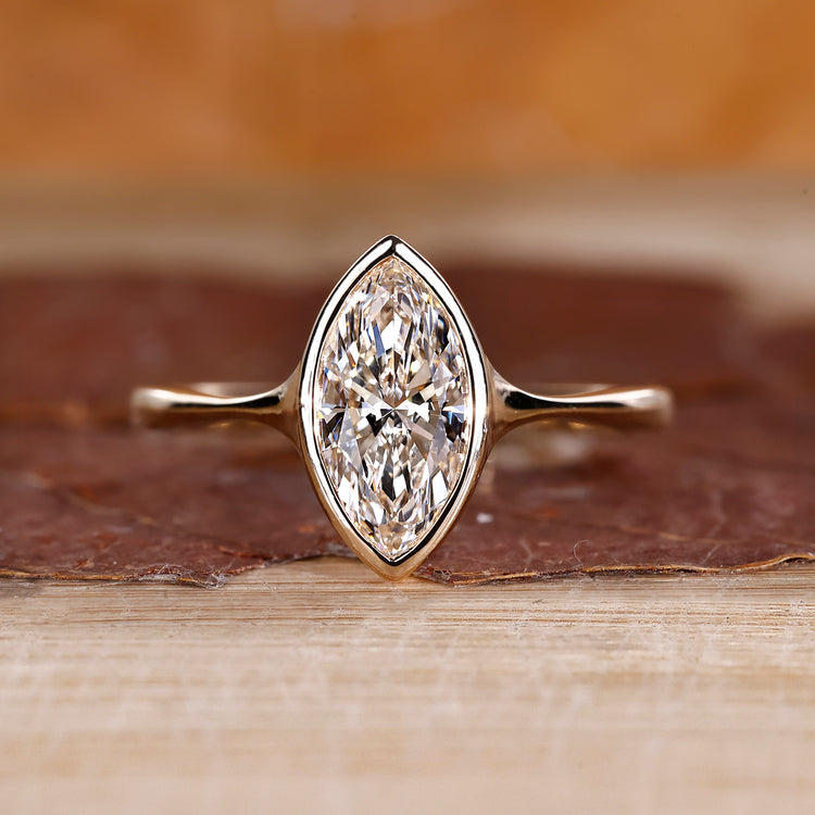 Marquise cut diamond engagement ring made with yellow gold.
