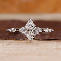 Dutch marquise diamond engagement ring with round cut side stone.
