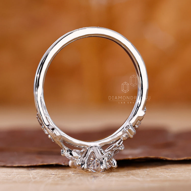 Lab grown diamond featured in an artistic vine ring.

