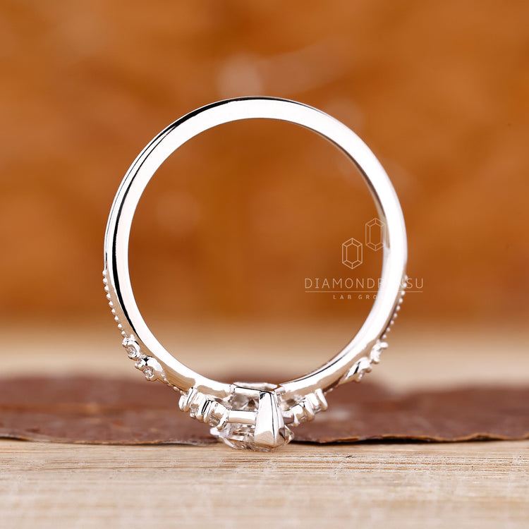 White gold diamond ring featuring milgrain detail and handmade design.
