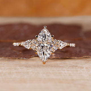 Marquise engagement ring with muse setting and kite side diamonds in yellow gold.
