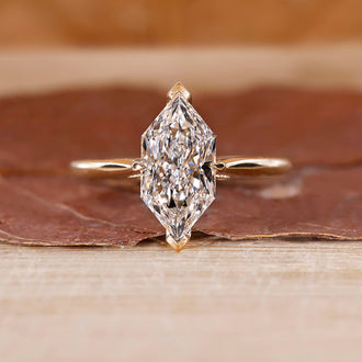 Dutch Marquise Engagement Ring with a round diamond and cathedral setting in yellow gold.

