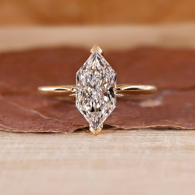 Dutch Marquise Engagement Ring with a round diamond and cathedral setting in yellow gold.
