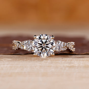 Round cut diamond engagement ring with twisted shank and pave setting.
