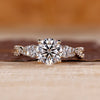 Round cut diamond engagement ring with twisted shank and pave setting.
