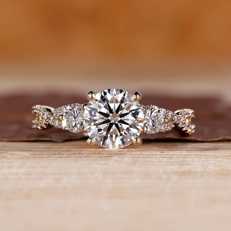 Round cut diamond engagement ring with twisted shank and pave setting.
