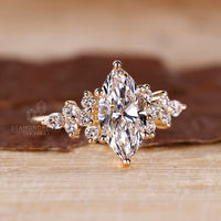 Muse setting engagement ring with pear and round side stones

