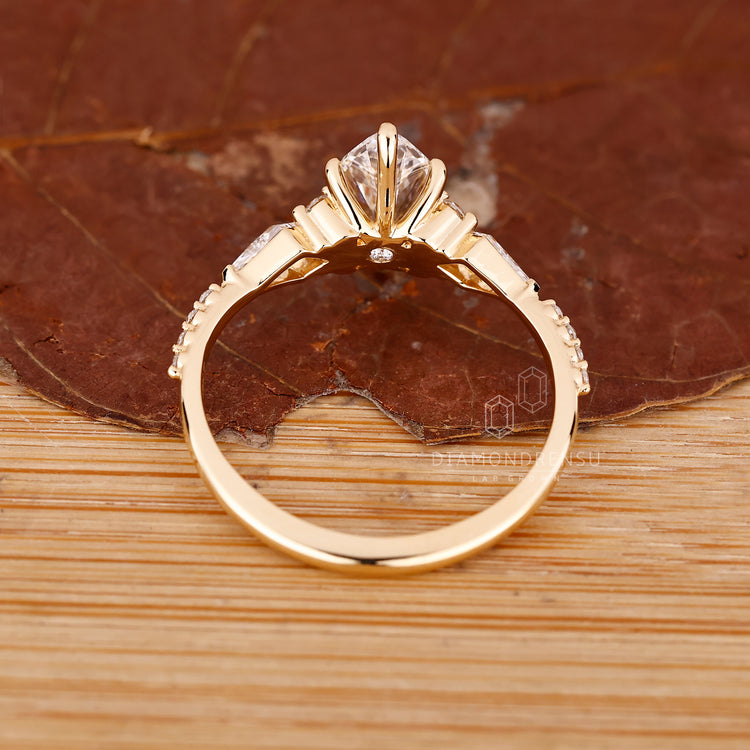 Buy engagement ring with marquise diamond and tapered shank yellow gold.
