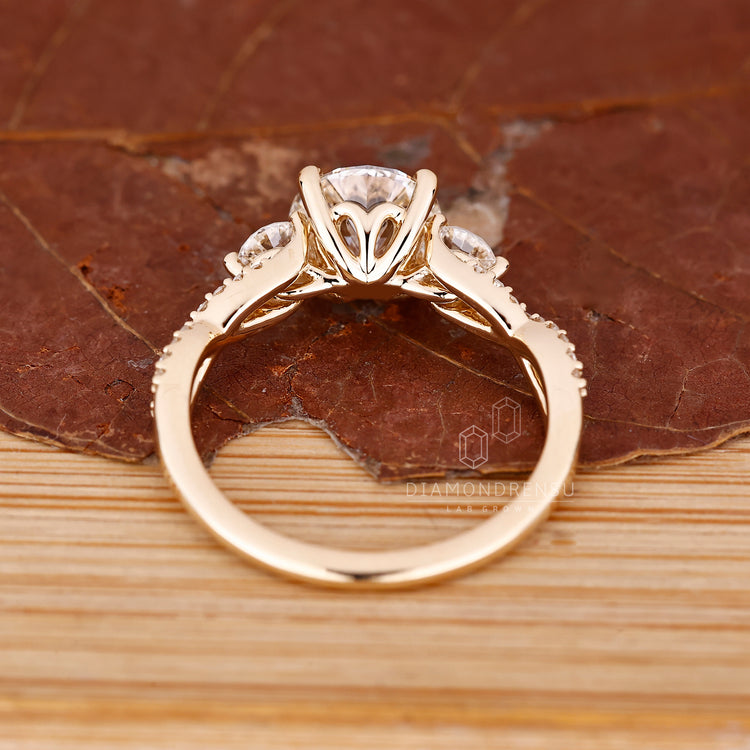 4 prong setting on round cut engagement ring with pave setting.
