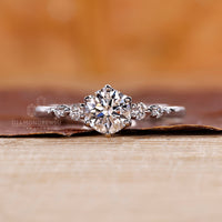 Lab grown diamond set in a diamond ring with tapered shank band, round cut side stones, and 6 round prong setting.
