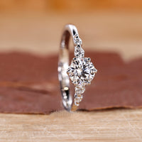 Round cut side stones set in a diamond ring with tapered shank band and IGI certified lab grown diamond.
