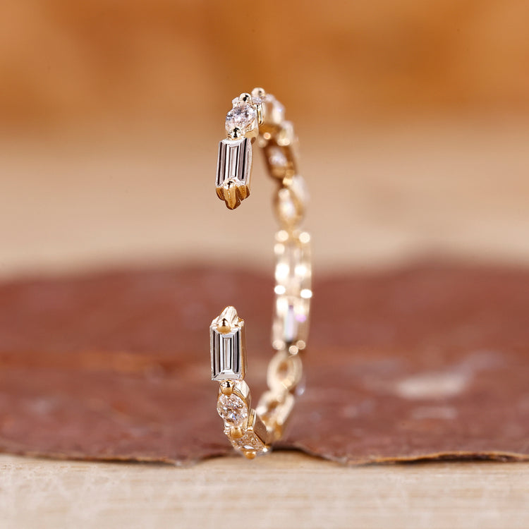 Marquise cut wedding band in a sleek yellow gold finish.
