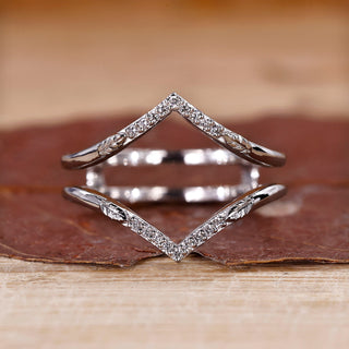 V shaped wedding band with round diamonds in white gold.
