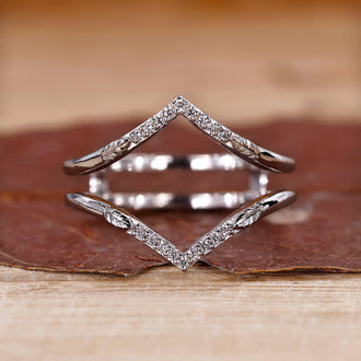 V shaped wedding band with round diamonds in white gold.
