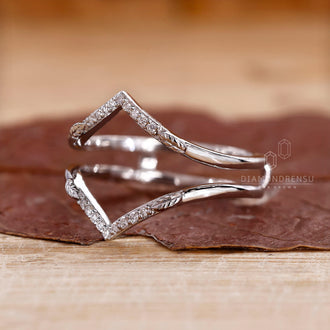 White gold diamond band featuring a leaf design.
