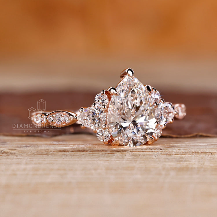 Custom engagement ring with pear cut and side stones.
