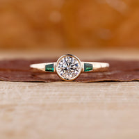 Three stone engagement ring featuring sparkling lab grown diamonds on a sleek band.
