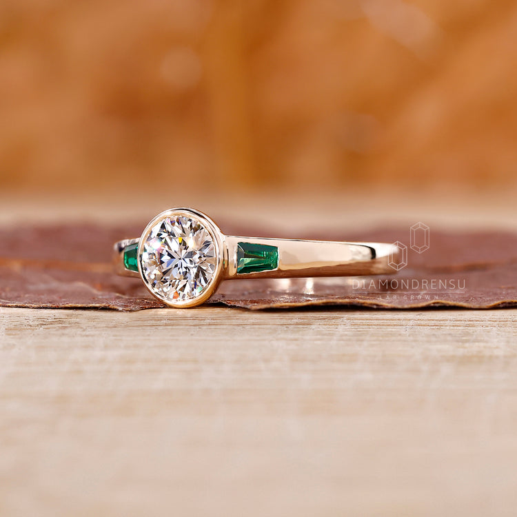 Bezel set engagement ring crafted in yellow gold for a smooth and modern finish.
