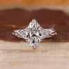Marquise cut engagement ring with seven stone diamonds in white gold.
