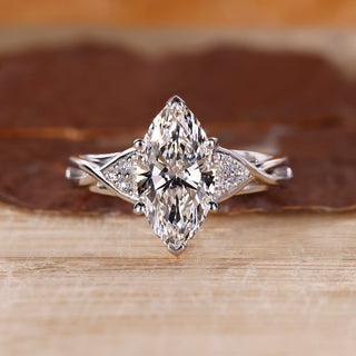 Marquise cut engagement ring with seven stone diamonds in white gold.

