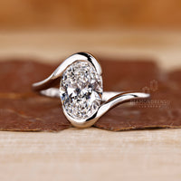 Solitaire engagement ring with oval diamond.
