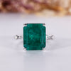 Emerald gemstone engagement ring in white gold.
