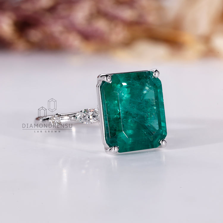 White gold emerald gemstone engagement ring.
