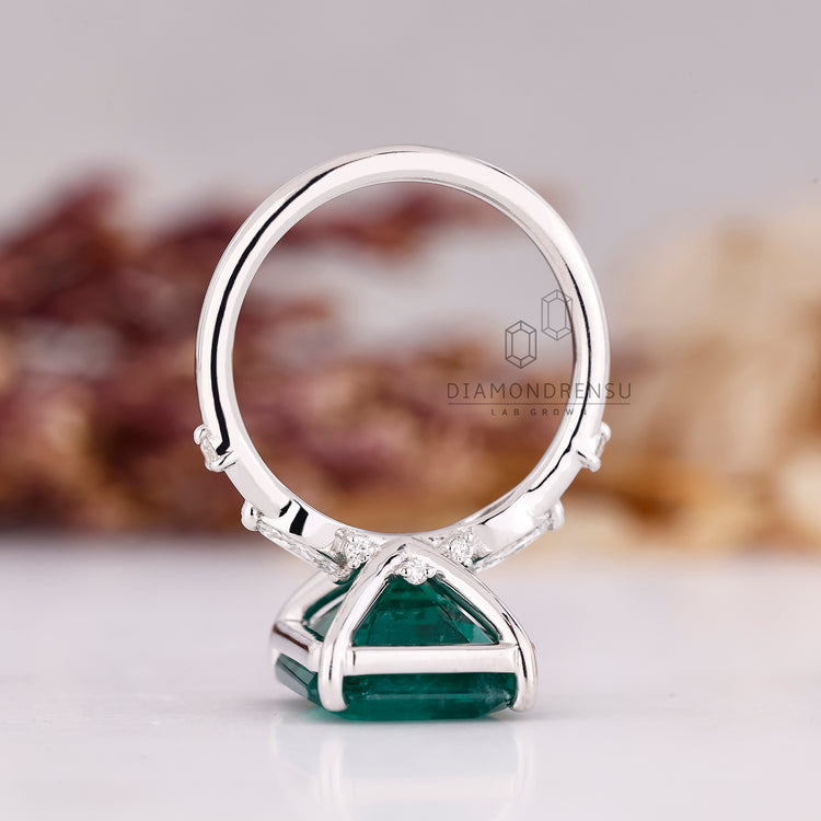 Elegant distance pave emerald engagement ring.
