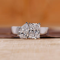 Toi et Moi ring featuring pear and radiant diamonds in white gold.
