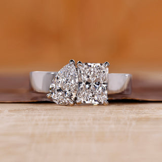 Toi et Moi ring featuring pear and radiant diamonds in white gold.
