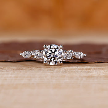 Marquise and round diamond ring in white gold setting.
