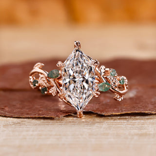 Nature-inspired marquise engagement ring with leaf-style pave design.
