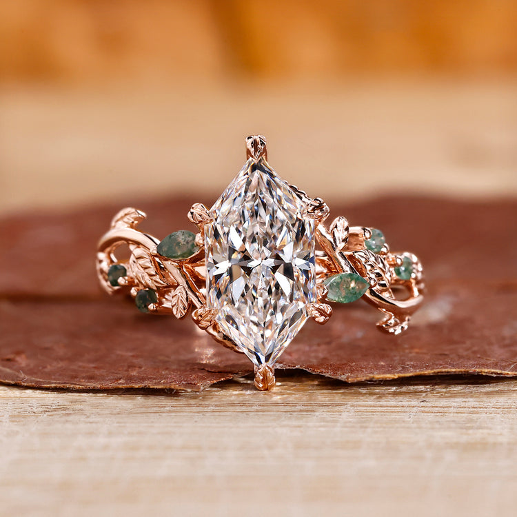 Nature-inspired marquise engagement ring with leaf-style pave design.
