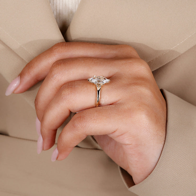 Buy engagement ring featuring Dutch marquise ring, solitaire setting, and 6 claw prong design in yellow gold.
