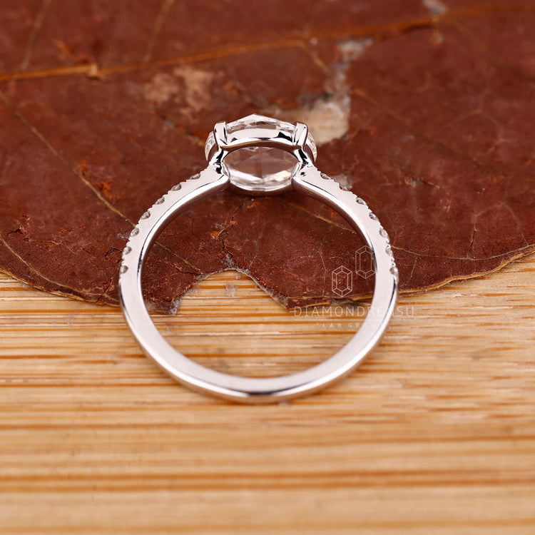 Custom diamond ring with rose cut engagement diamond and open gallery.
