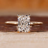 Radiant cut engagement ring featuring solitaire setting and hidden halo diamond.
