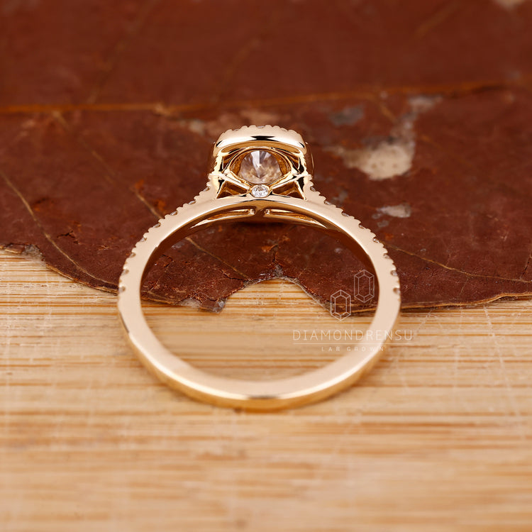 Halo engagement ring with round diamond accents.
