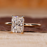 Hidden halo diamond ring with radiant cut solitaire in yellow gold.
