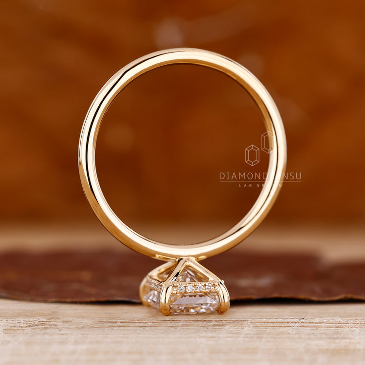 Custom diamond ring with radiant cut solitaire and hidden halo design.
