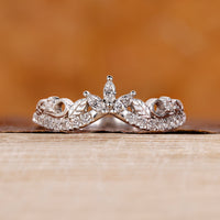 Round diamond wedding band in white gold with prong setting.
