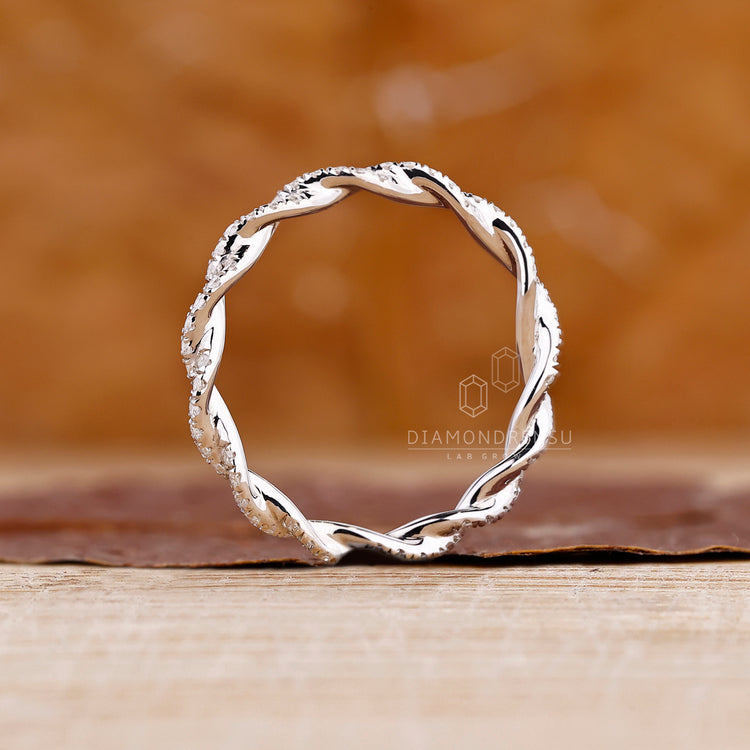 Handmade band with round diamonds in a twisted full eternity wedding band design.
