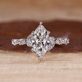Marquise cut diamond ring in white gold with nature inspired design.
